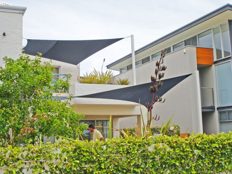 Charcoal shade sails over a residential courtyard