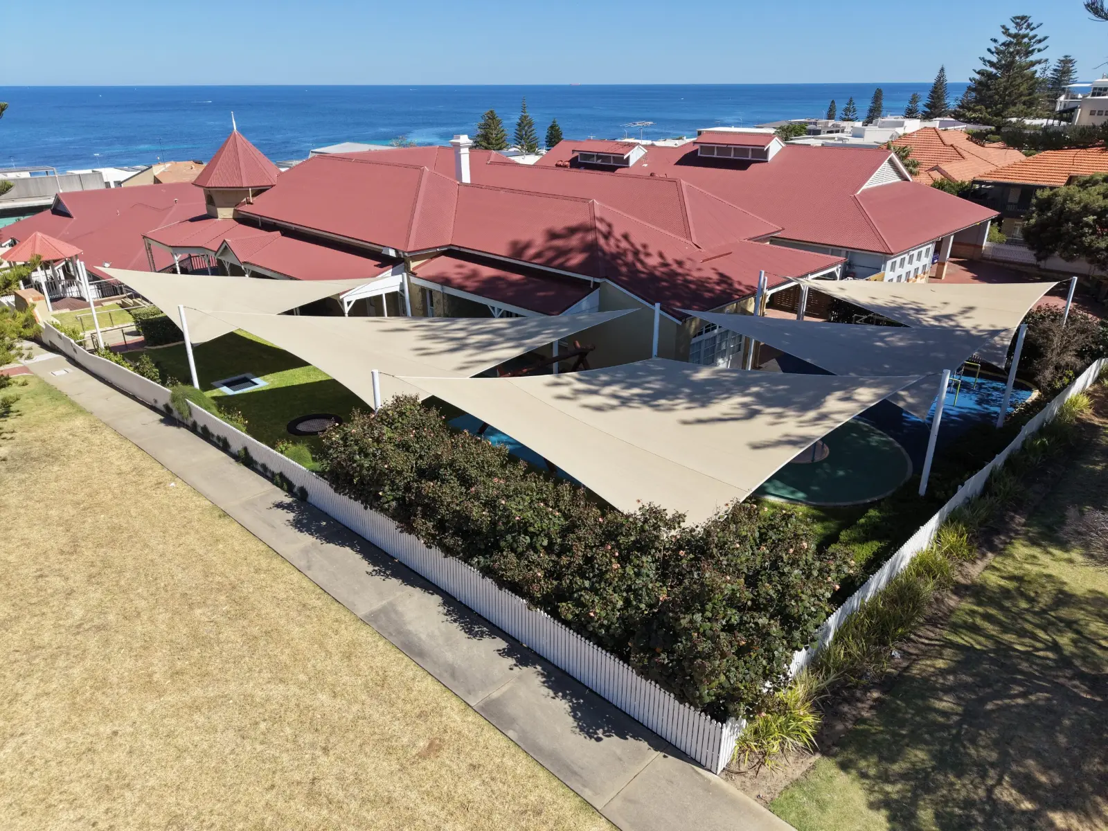 Cream shade sails over an outdoor area near the coast in Perth