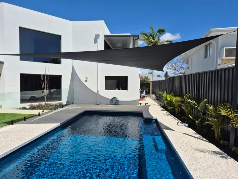 Black shade sails over a residential swimming pool in Perth