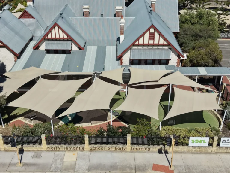 Cream shade sails over a courtyard in front of a heritage building in North Fremantle